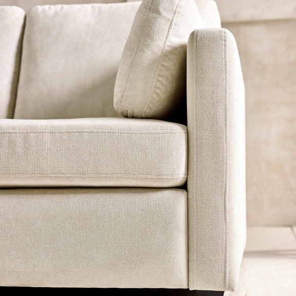 Close-up of a beige fabric sofa corner