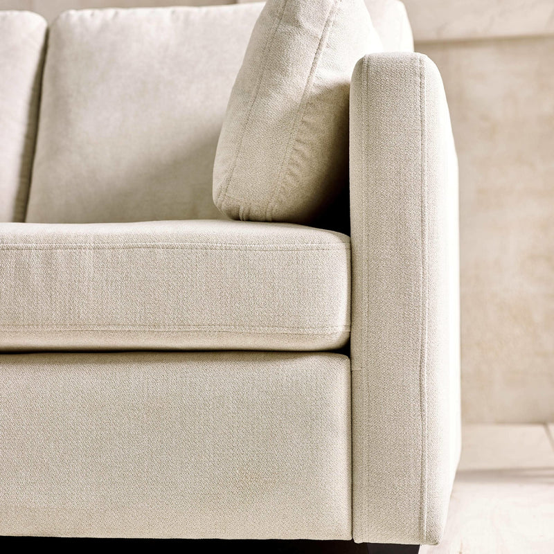 Close-up of a beige fabric sofa corner