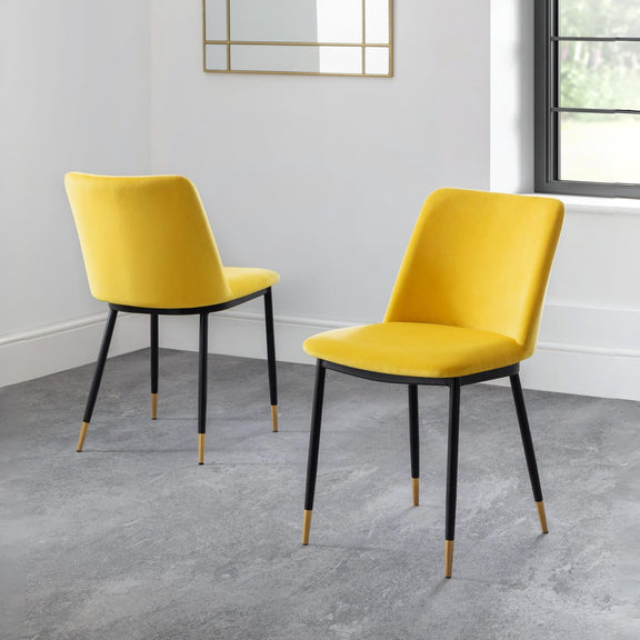 Two yellow chairs with black legs on a gray floor.