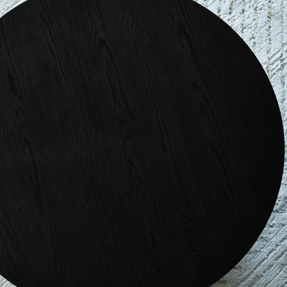 Black circle on a textured gray background