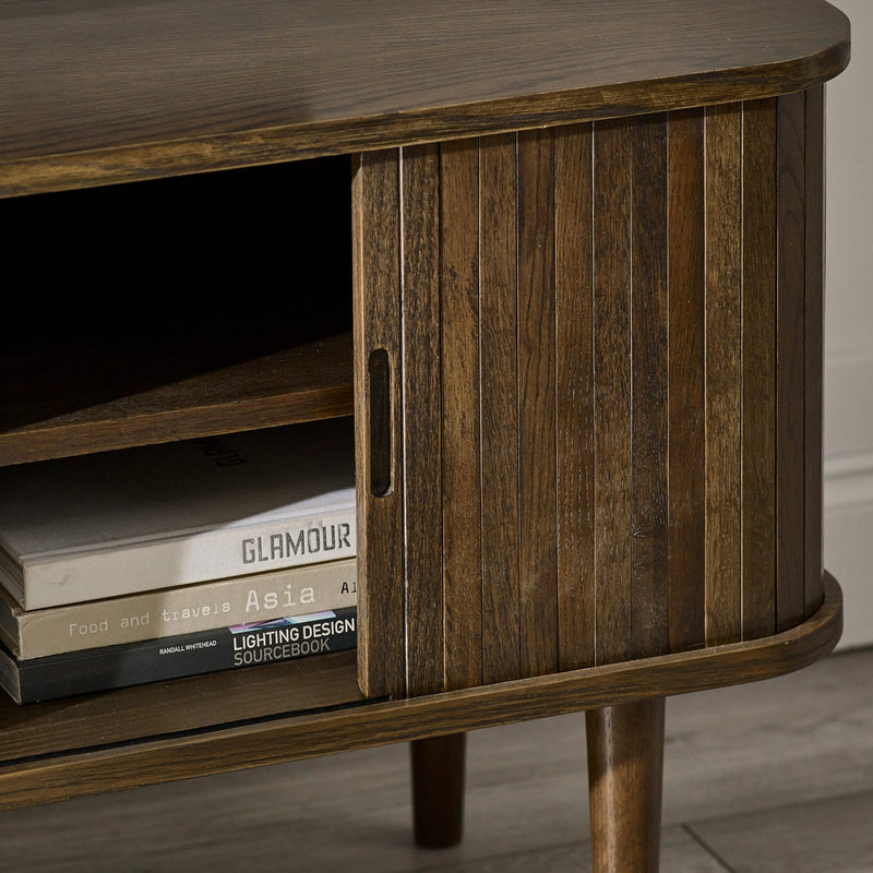 Wooden side table with books on a neutral background