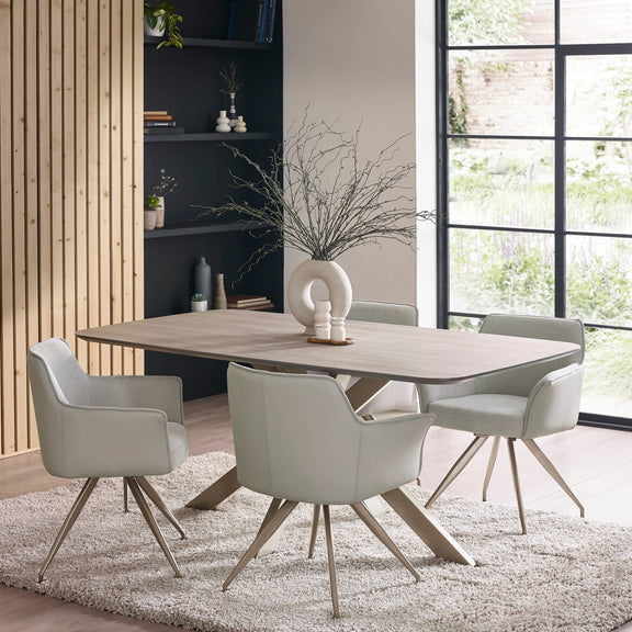 Dining room with a wooden table and gray chairs in a modern interior setting.