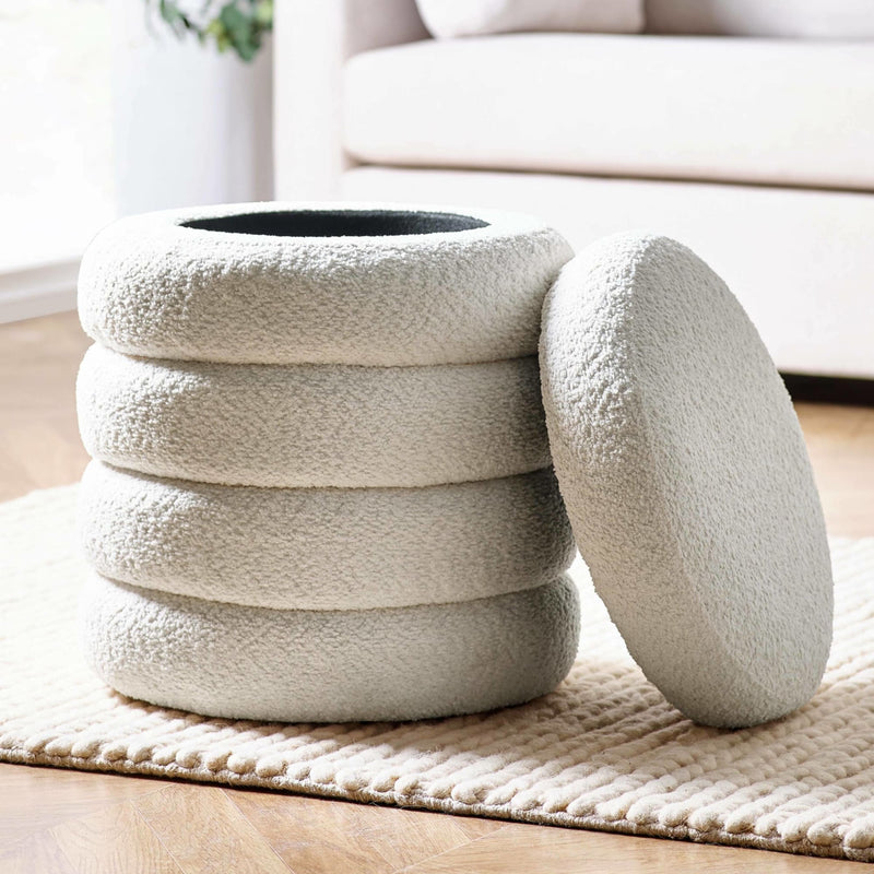 White textured stool on a wooden floor with a light-colored rug and a blurred background.
