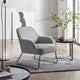 Gray armchair in a modern living room with a side table and decorative elements.