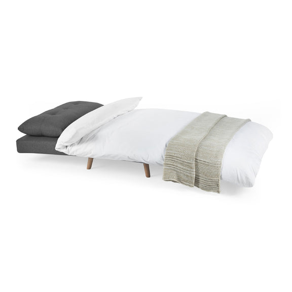 Bed with gray, white, and green bedding on a white background