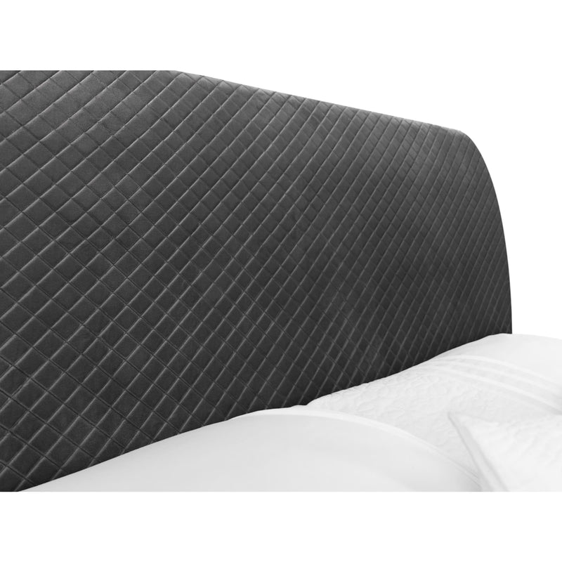 Gray quilted headboard on a bed with white bedding