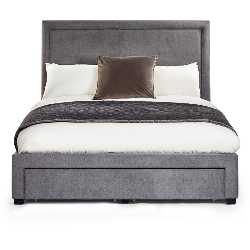 Gray upholstered bed with white bedding and brown throw blanket on a white background