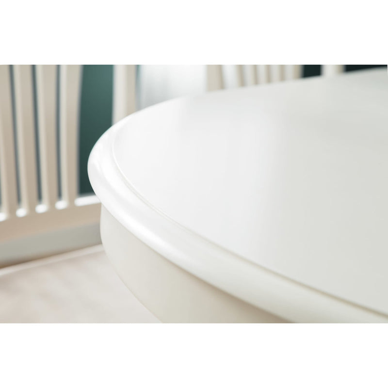 Close-up of a white toilet seat in a bathroom setting