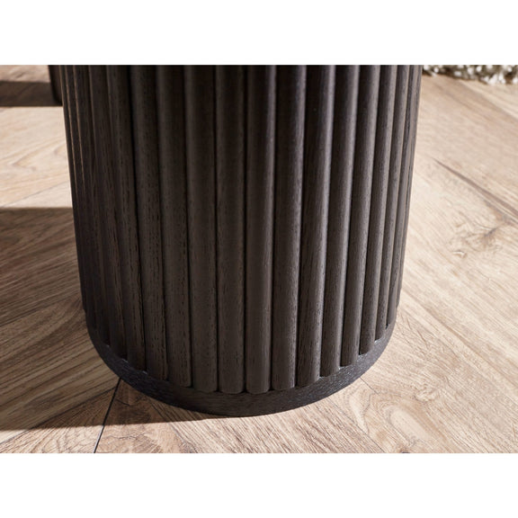 Dark cylindrical object on a wooden floor