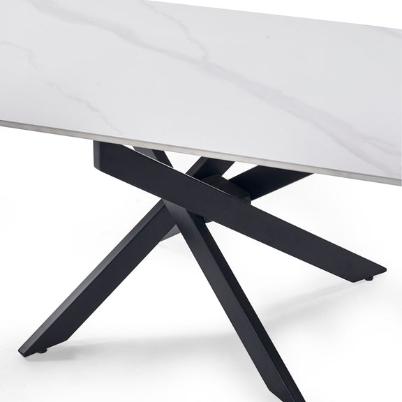 Close-up of a table with a white marble top and black metal legs on a white background