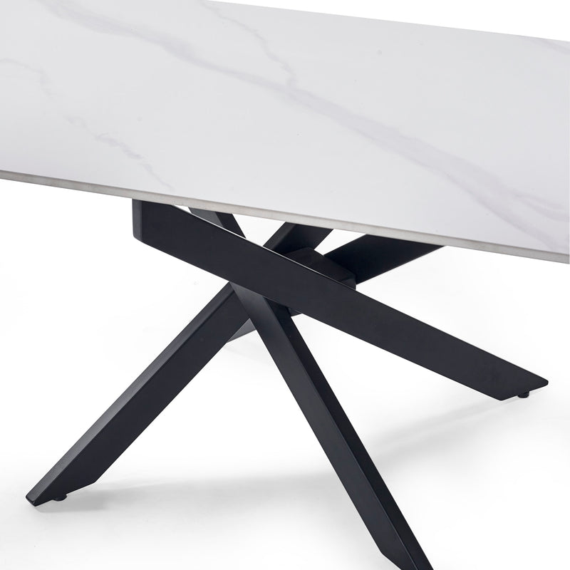 Close-up of a table with a white marble top and black metal legs on a white background