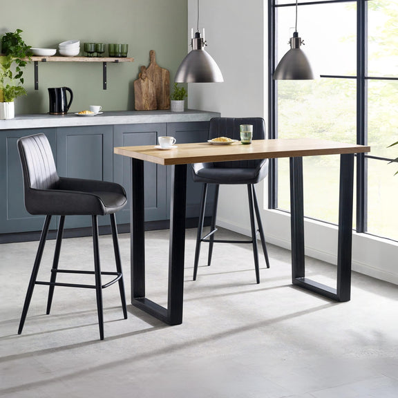 Modern kitchen with a wooden dining table and black bar stools.