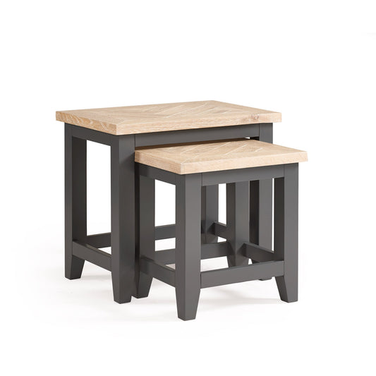 Set of two nesting tables with wooden tops and black frames on a white background