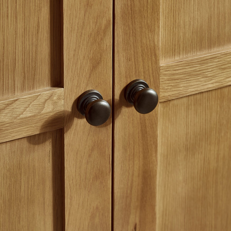 Close-up of wooden cabinet doors with black knobs