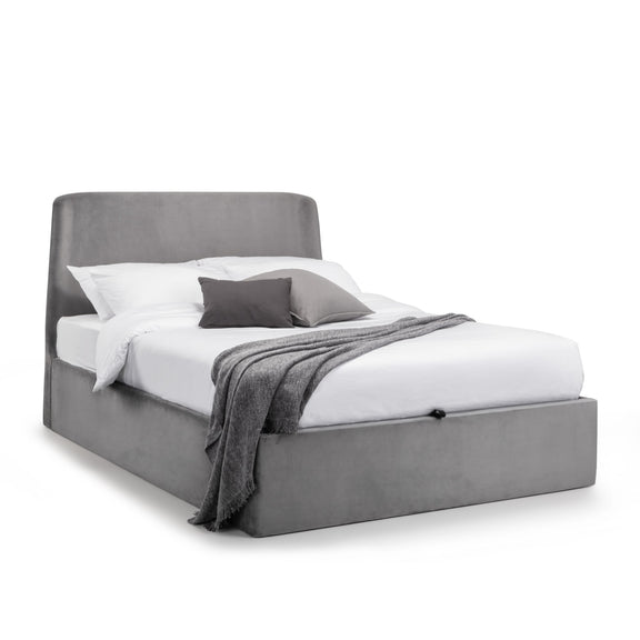 Gray upholstered bed with white bedding and gray blanket on a white background