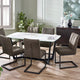 Dining room with a round table and gray chairs on a wooden floor.