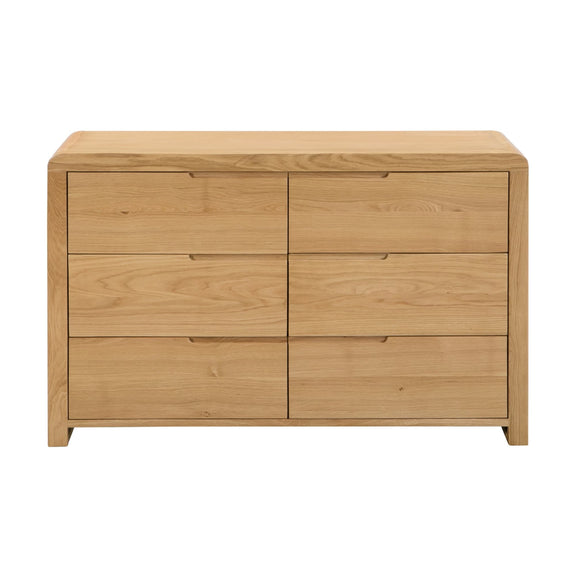 Wooden dresser with four drawers on a white background