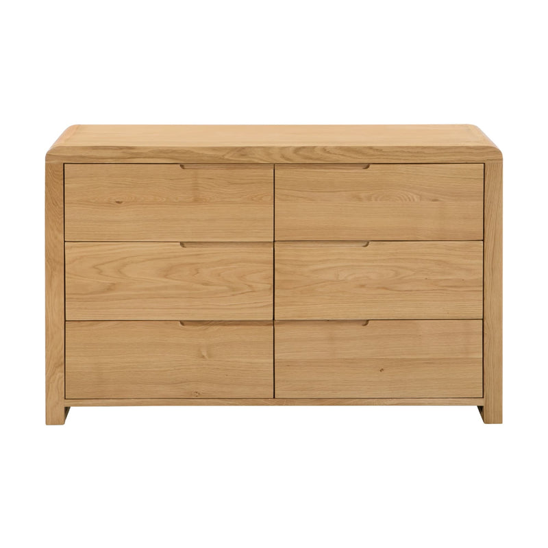 Wooden dresser with four drawers on a white background
