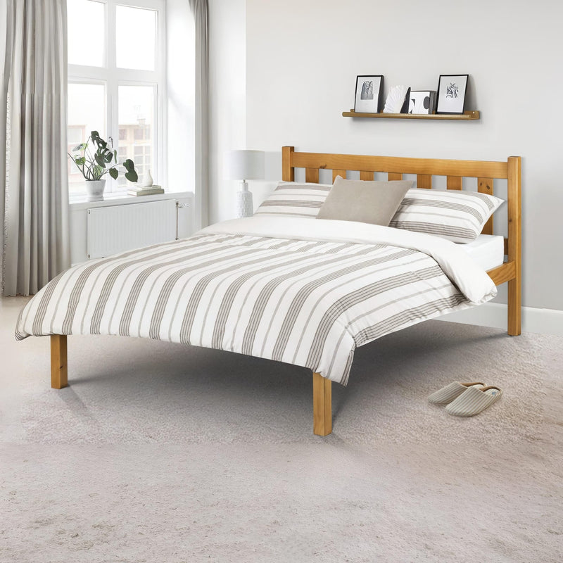 Wooden bed with striped bedding in a bright bedroom