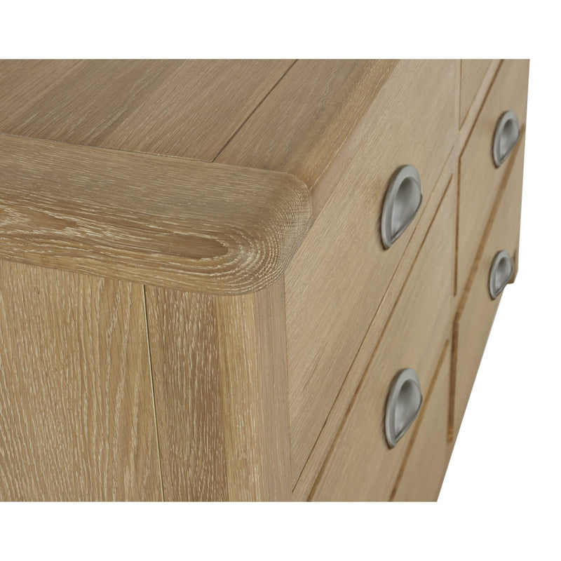 Close-up of a wooden drawer with metallic handles on a white background