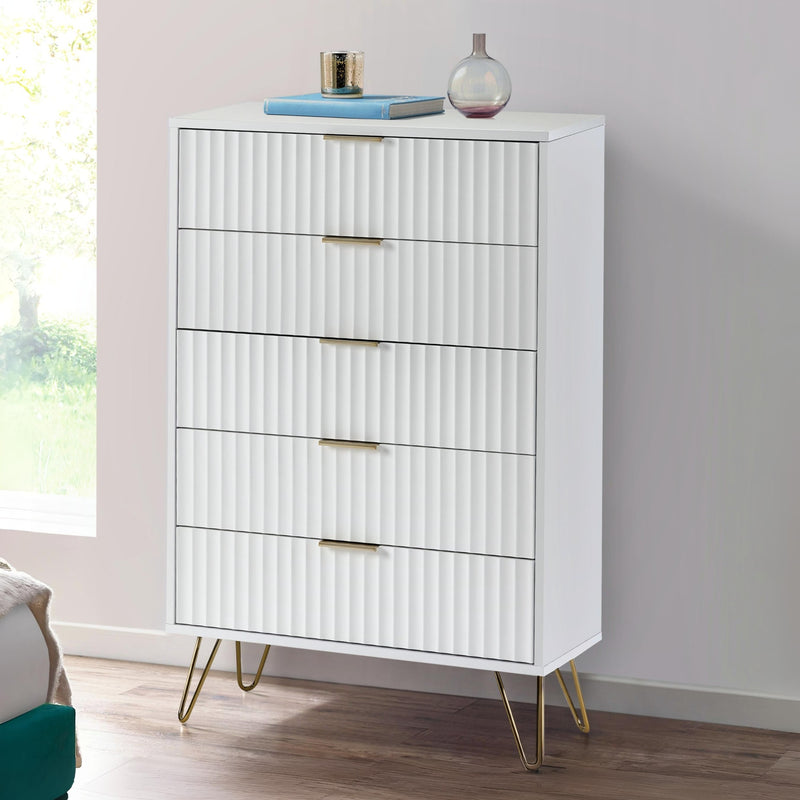 White dresser with gold legs in a room with a window and gray wall.