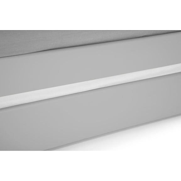 Close-up of a white LED strip light on a gray background