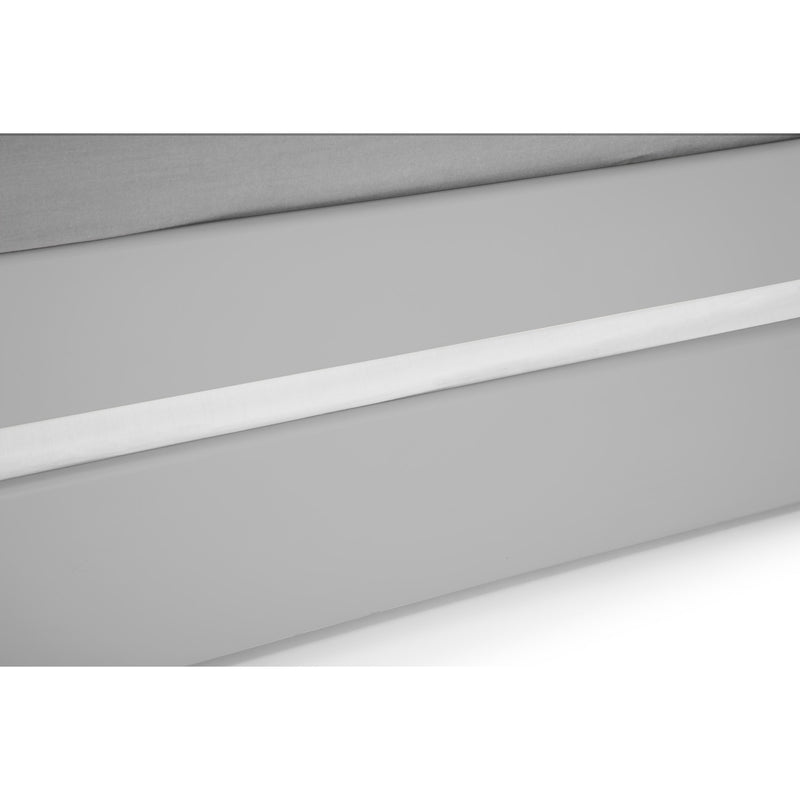 Close-up of a white LED strip light on a gray background