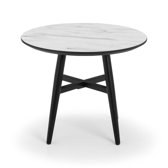 Round table with white marble top and black legs on a white background
