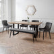 Dining room with wooden table and gray chairs on a parquet floor.