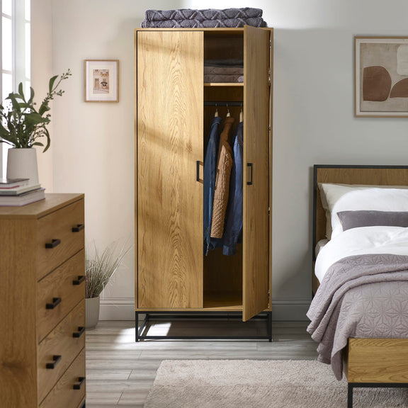 Wooden wardrobe with clothes in a bedroom setting