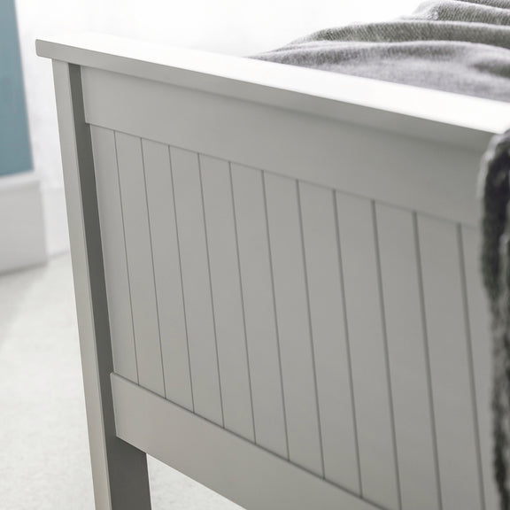 Gray wooden headboard with a blurred background