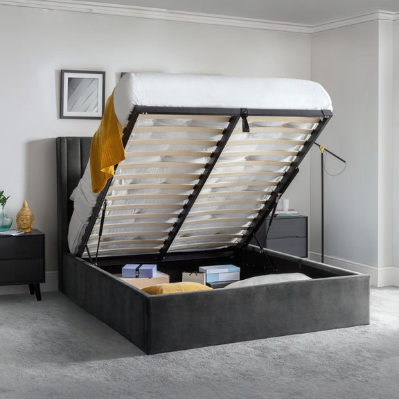 Gray upholstered bed with open storage compartment in a bedroom setting