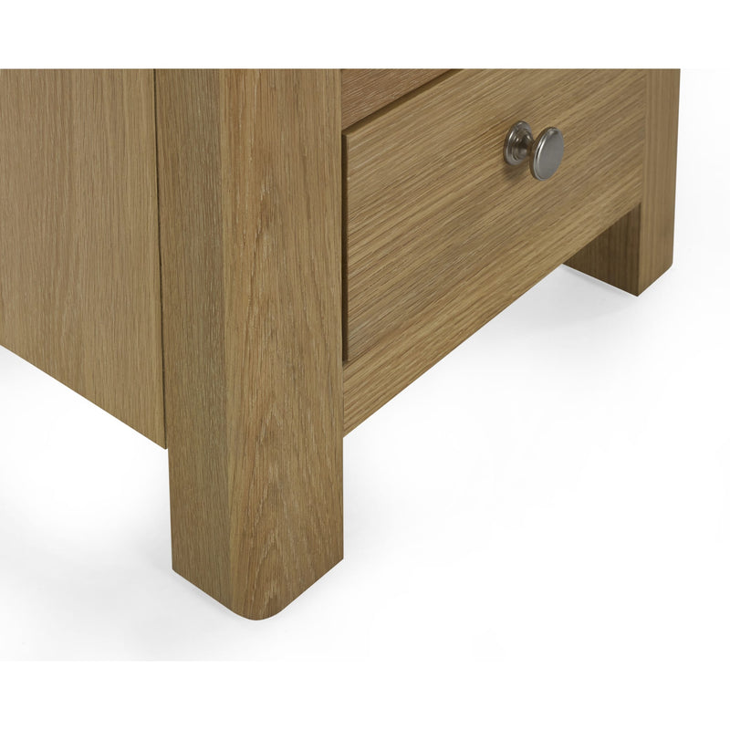 Wooden drawer with a metallic handle on a white background