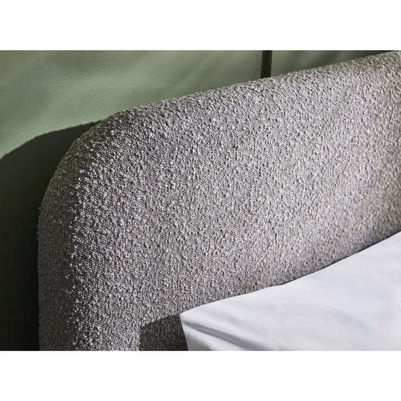 Textured headboard with a white pillow on a neutral background