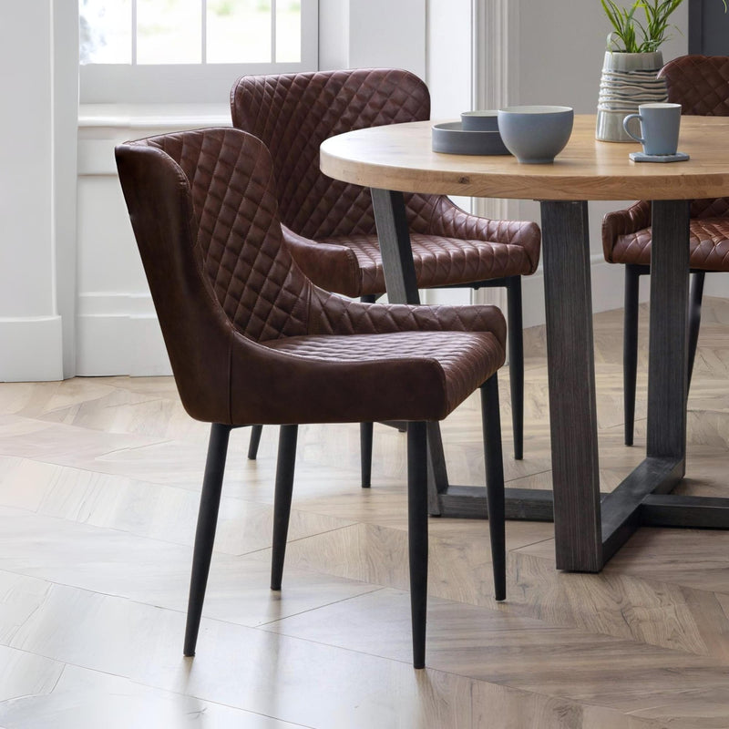 Dining room with brown chairs and a wooden table.