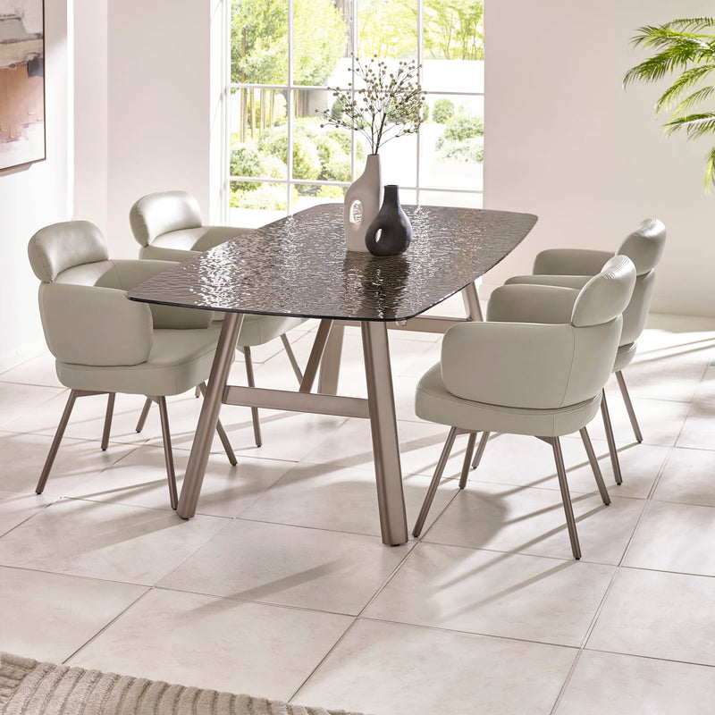 Dining room with a modern table and chairs in a bright room.