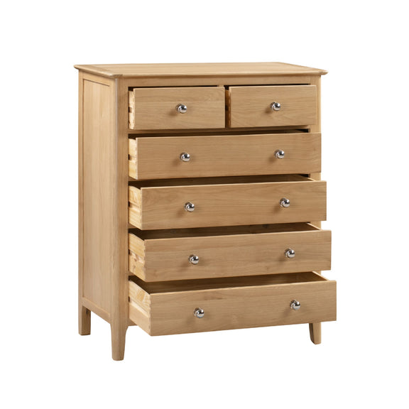 Wooden dresser with five drawers on a white background