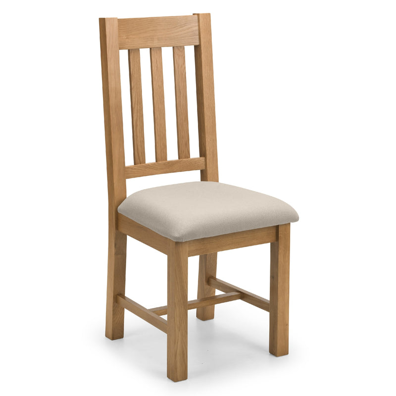 Wooden chair with a beige cushion on a white background