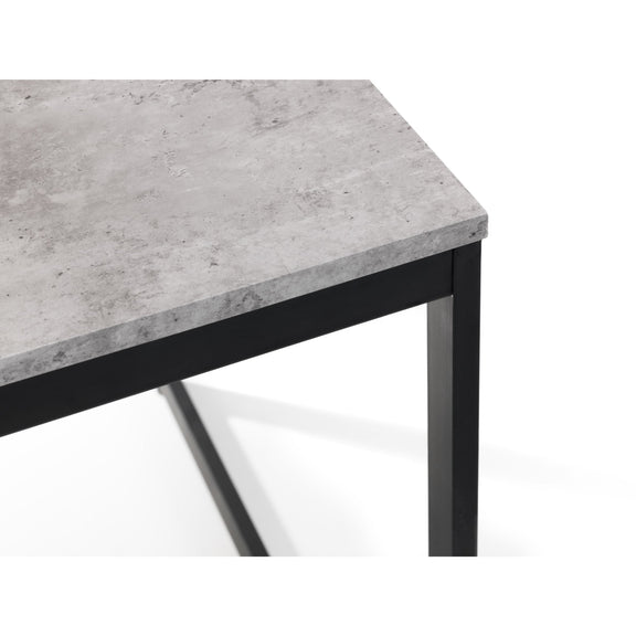 Table with concrete-like top and black metal legs on a white background