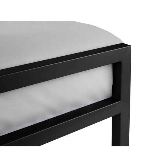Close-up of a black metal frame with a white cushion on a white background