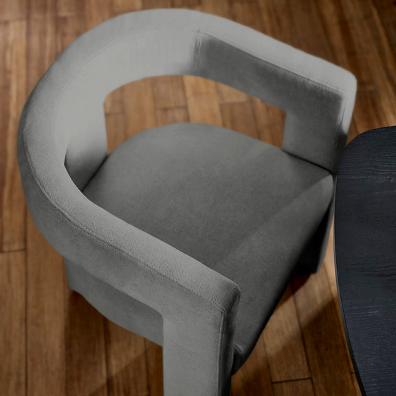 Gray chair with armrests on a wooden floor