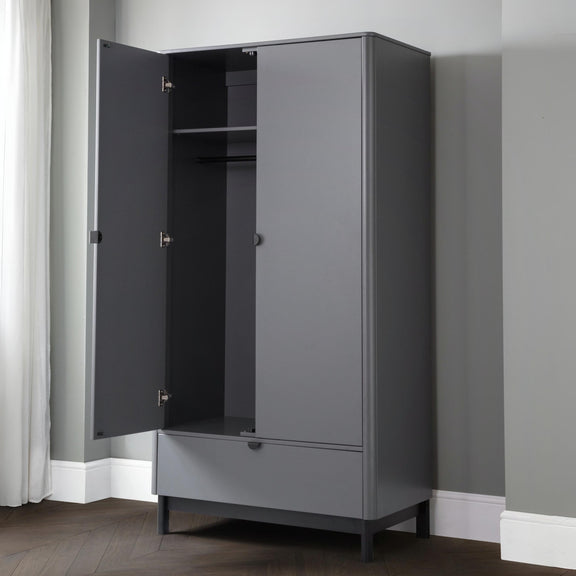 Gray wardrobe with open door in a room with gray walls and white baseboards.