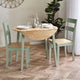 Dining table with chairs in a room with a plant and decorative wall piece.