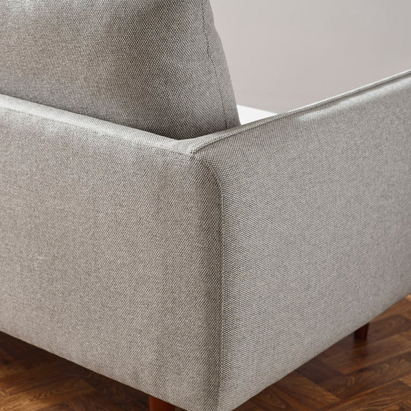 Gray upholstered chair corner on a wooden floor