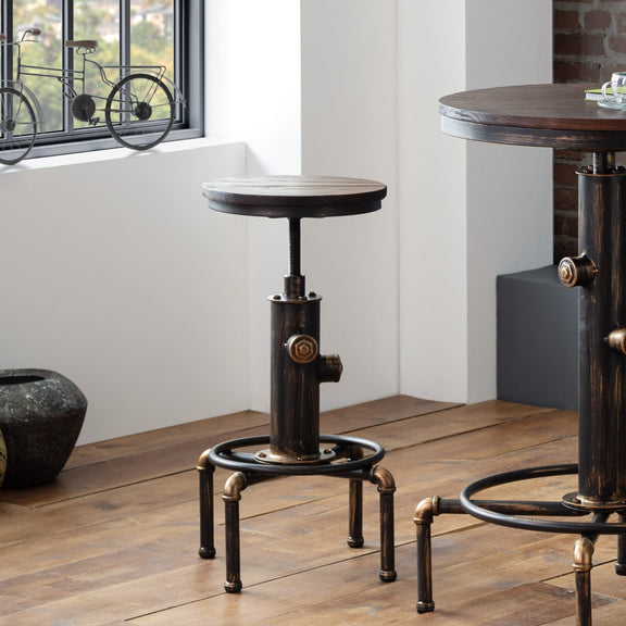 Two round tables with industrial design on a wooden floor.