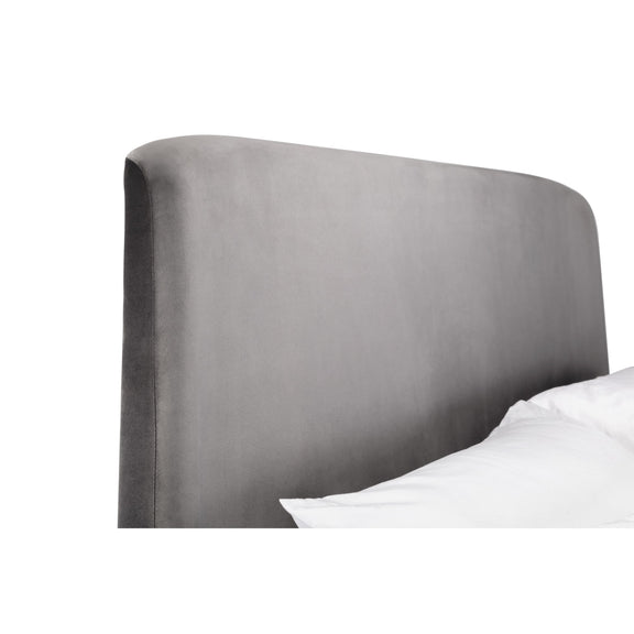Gray upholstered headboard with white bedding on a white background