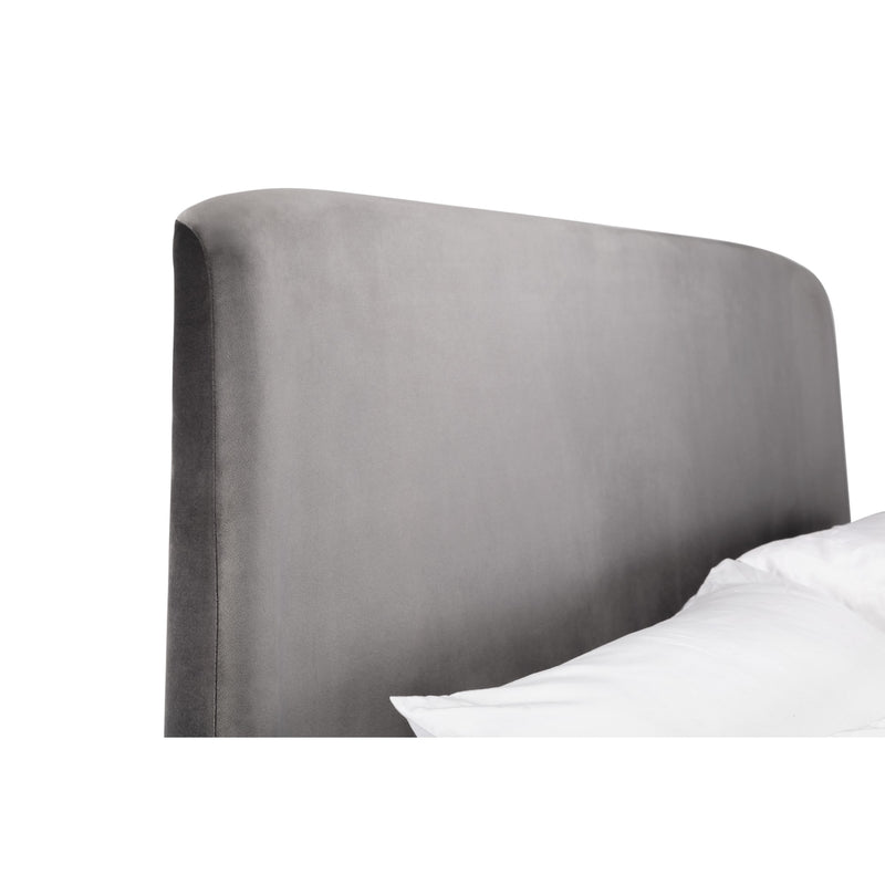 Gray upholstered headboard with white bedding on a white background