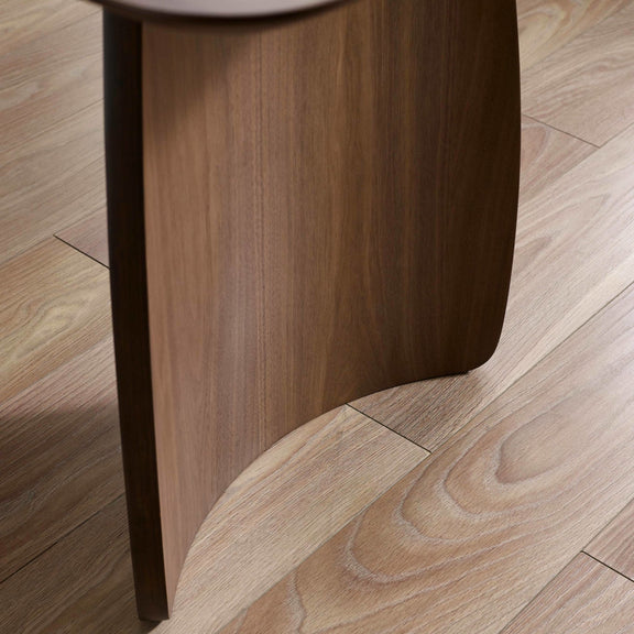Close-up of a wooden stool leg on a wooden floor