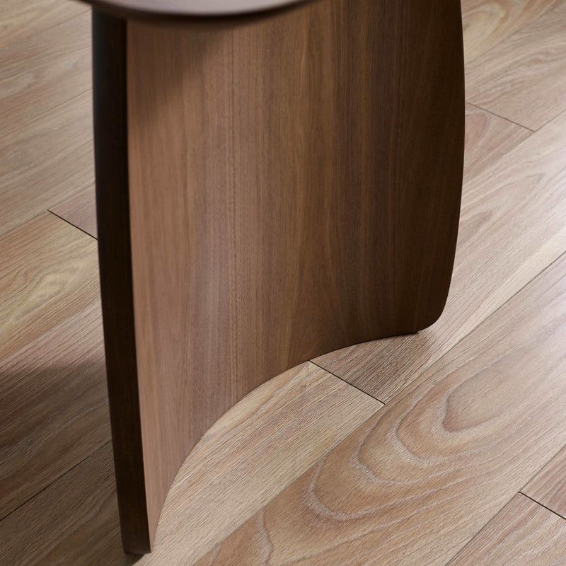 Close-up of a wooden stool leg on a wooden floor