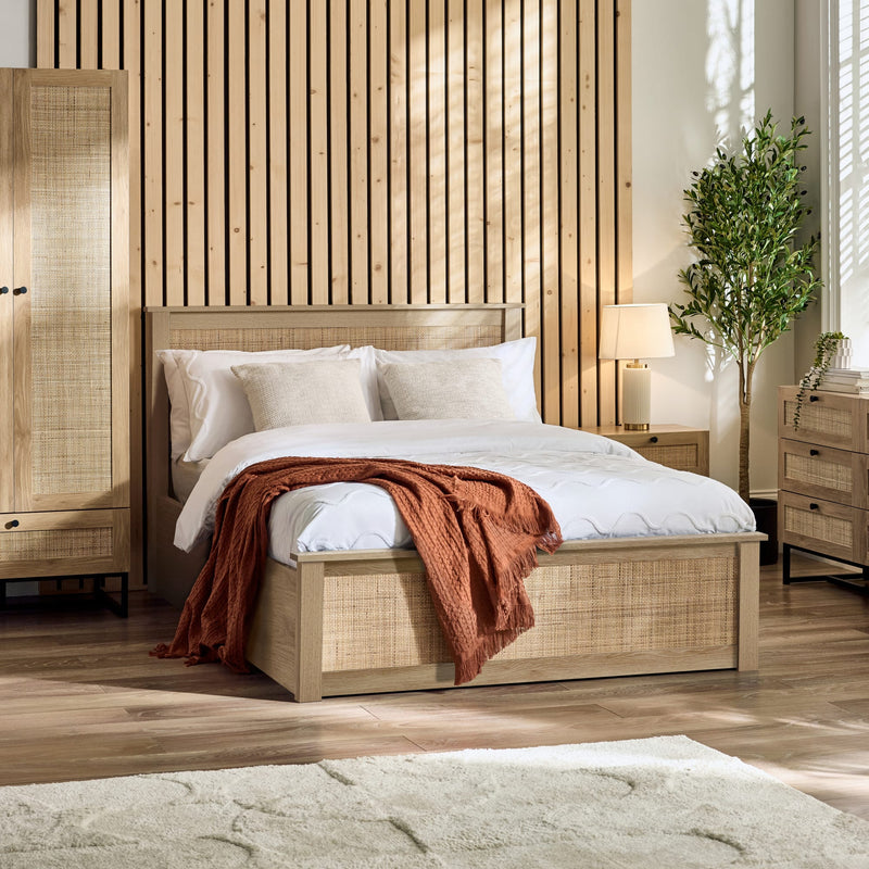 Wooden bedroom set with bed, nightstands, and lamp in a well-lit room.